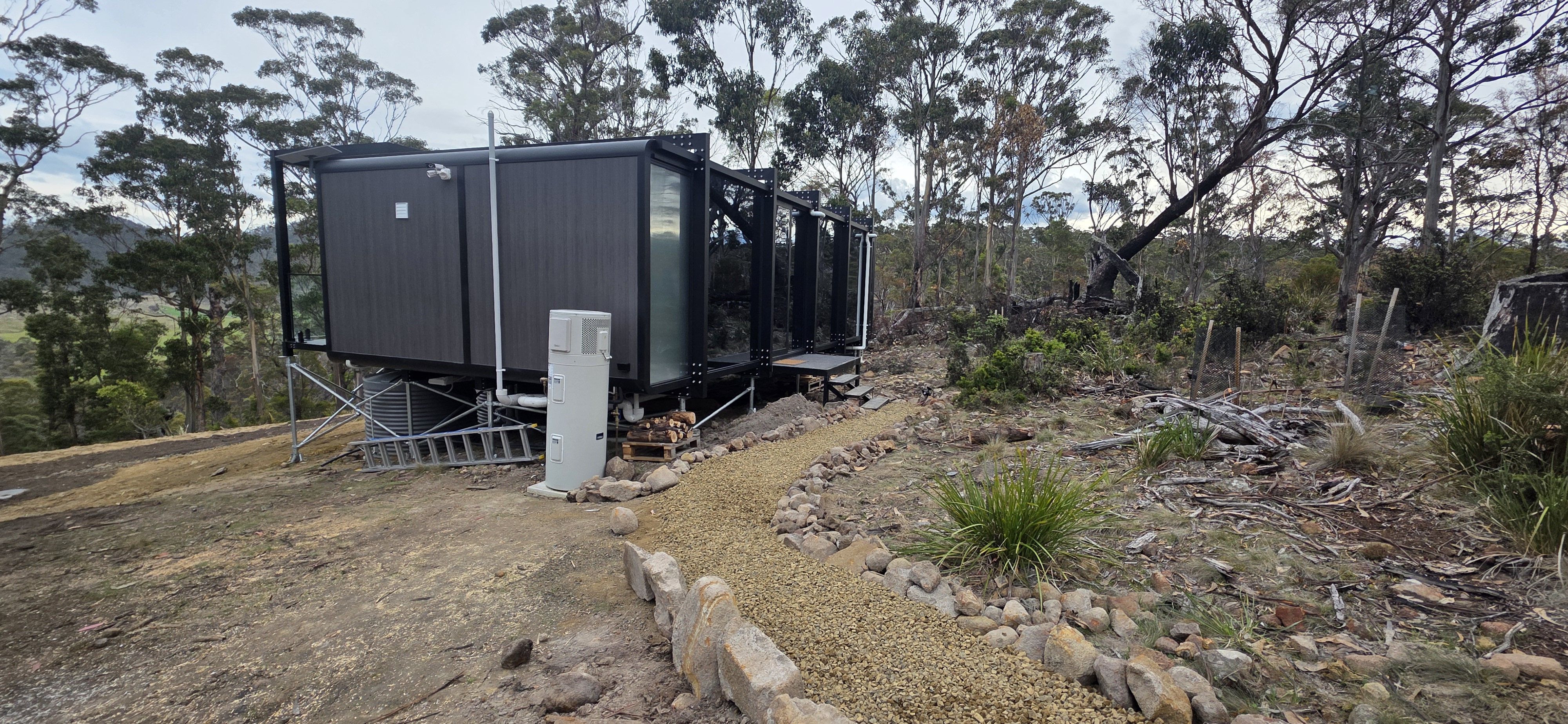 The pod and gravel path surrounded by native Tasmanian bushland